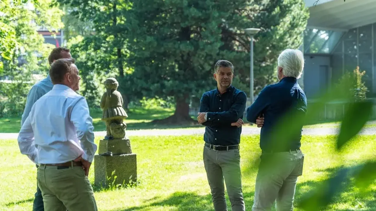 Rådgivere fra Oplandske i samtale utendørs en sommerdag